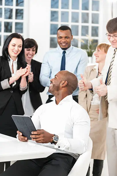 Photo of Clapping business people