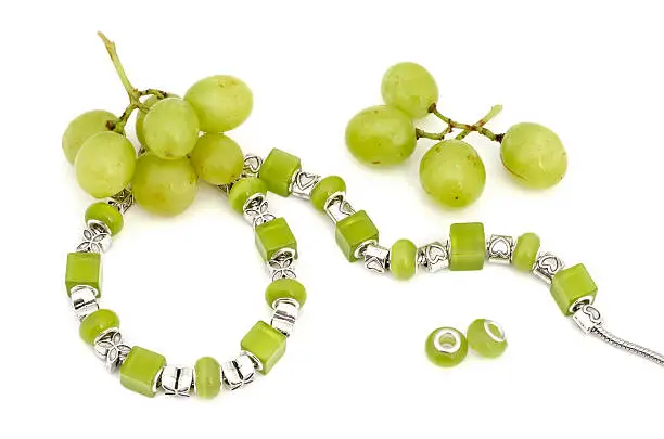 Green pandora bracelet and grapes - modern fashion jewellery advertising