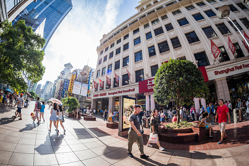 Shanghai, Сhina - Aug 13, 2016: Nanjing Road is Shanghai's busiest shopping street. Crowds of tourists are going sightseeing and enjoying the view of the street.