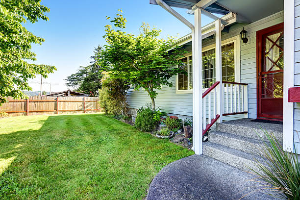 istock House exterior with blue siding trim, red front door 590050490
