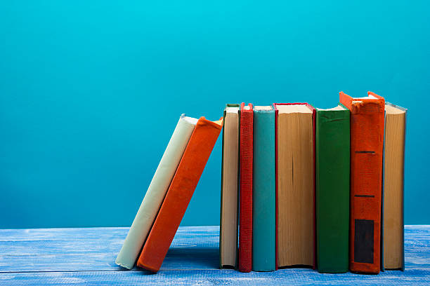 istock Stack of hardback books on wooden table. Back to school 590051164