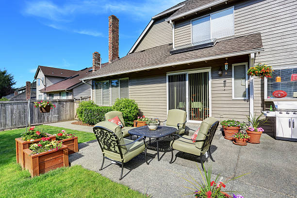 istock Well kept garden at backyard with concrete floor patio area 590052336