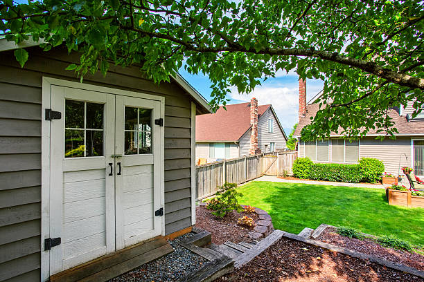 istock Well kept garden at backyard with barn shed 590052938