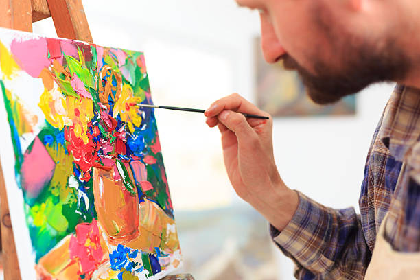 istock Close up of painter creating art at his workshop 590055084
