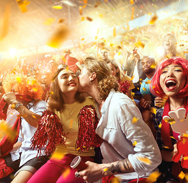 istock Sport fans: Man kisses woman 590055962
