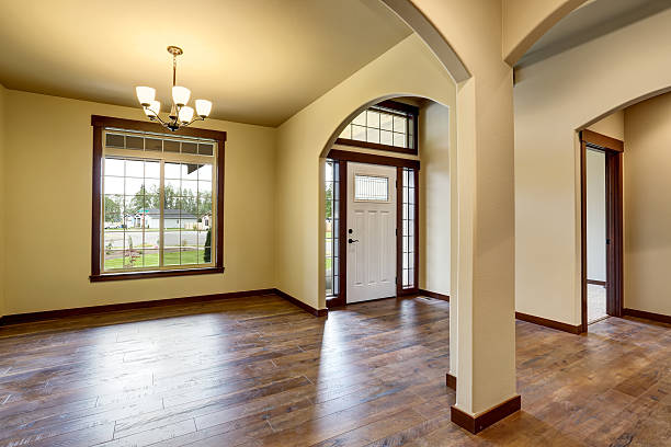 istock Hallway interior with columns, hardwood floor and white entry door 590056650