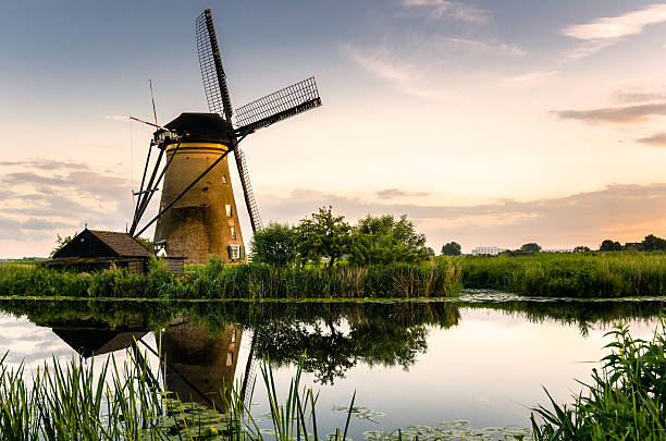 istock Beautiful Sunset over a Traditional Dutch Windmill 590057296