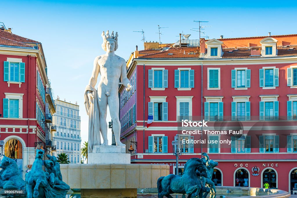 Fountain of the Sun, Nice, France Nice, France - August 12, 2016: A view of 'Fontaine du Soleil' in Nice in the South of France. In the background is a shop for the local football team with various logos and products.  City Stock Photo