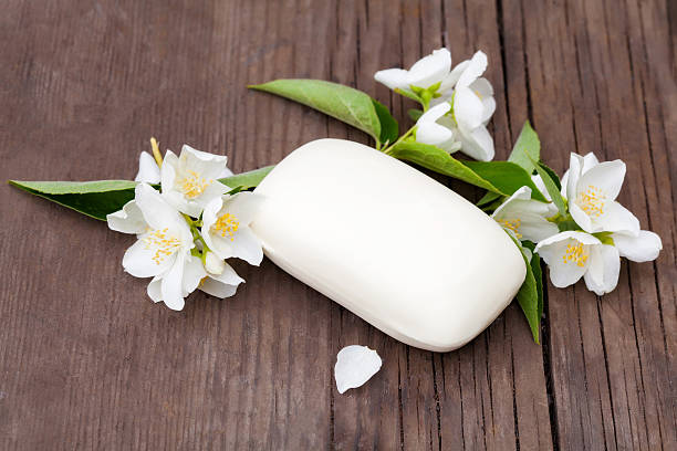 istock Jasmin flowers and soap on a old wooden table 590058938