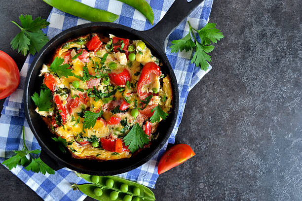istock frittata with tomatoes, peppers, green peas 590058962