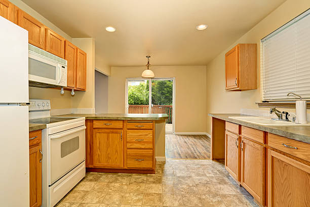 istock Classic American kitchen room with wooden cabinets and tile floor. 590059762