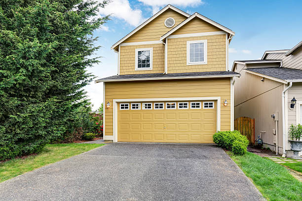 istock Curb appeal. Yellow two level house exterior with garage. 590059862