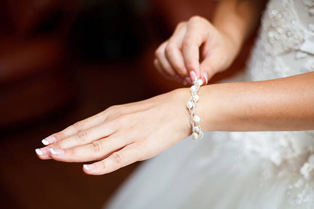 istock Bride wrapping pearl bracelet on hand 590059986