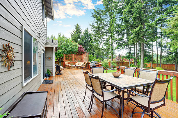 istock Spacious wooden deck with patio area and attached pergola. 590060194