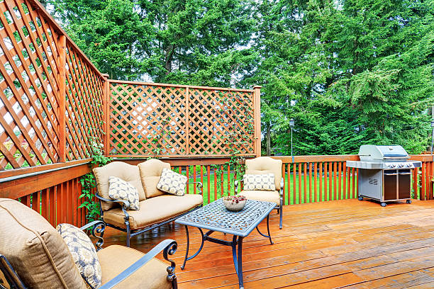 istock Spacious wooden deck with patio area and attached pergola. 590060362