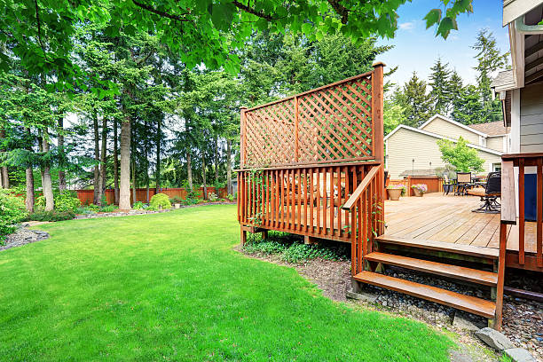 istock Spacious wooden deck with patio area and attached pergola. 590060572