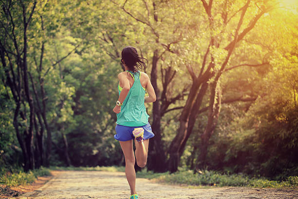 istock young woman trail runner running at forest stone trail 590060586