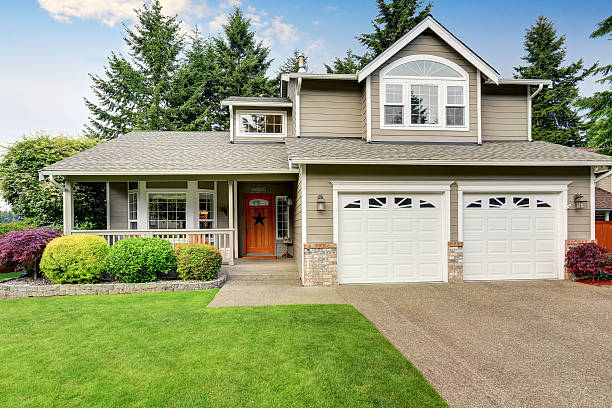 American house exterior with double garage and well kept lawn. Curb appeal. American house exterior with double garage, concrete floor porch and well kept lawn. Northwest, USA front door photos stock pictures, royalty-free photos & images