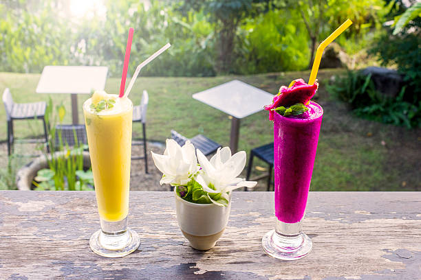 istock Fresh jackfruit juice and dragon fruit juice with garden background 590062068