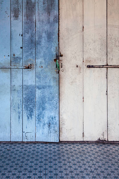 istock Worn old wooden door locked 590062162