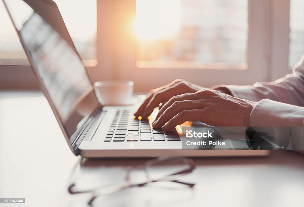 Man using laptop computer Businessman using smart phone and laptop computer Laptop Stock Photo