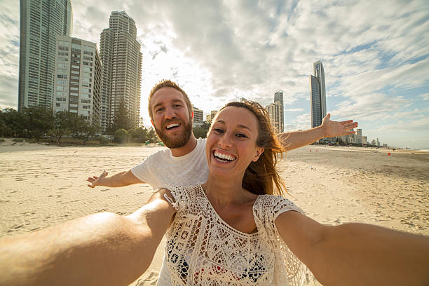 istock Young couple capturing summer vacation moments 590062304