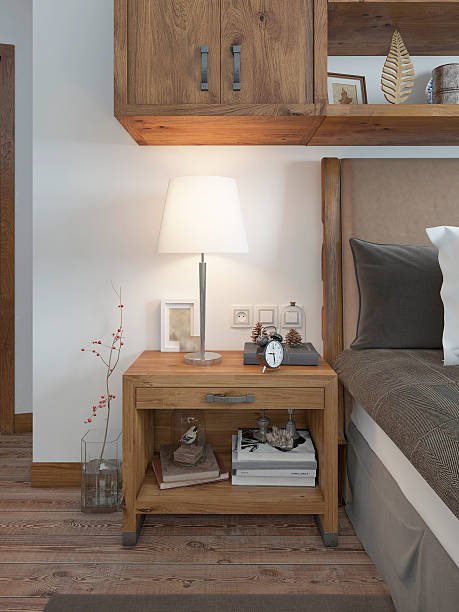 Wooden bedside table with a niche for the decor. Bedside table with lamp and books beside the bed. A bed in a rustic style. 3D render.