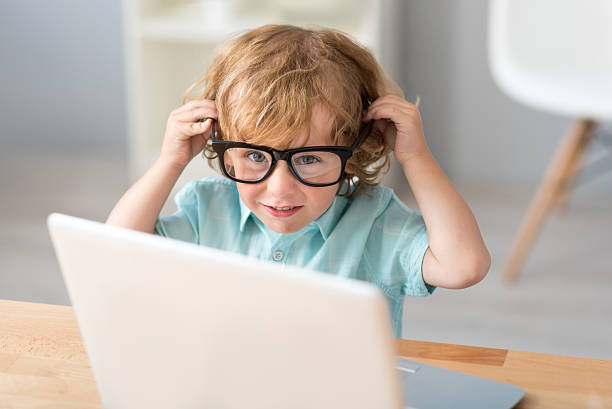 istock Little boy putting on glasses 590062902