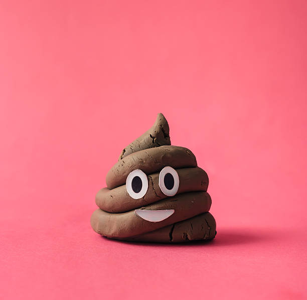Poop emoticon on pink background. Poop emoticon on pink background. animal dung stock pictures, royalty-free photos & images