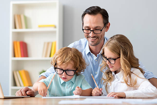 istock Man and girl how boy drawing 590063590
