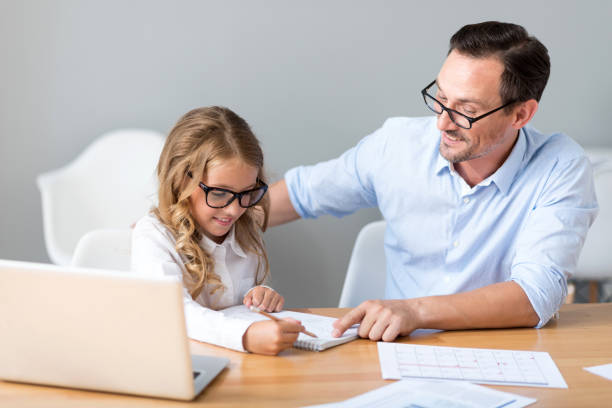 istock Man and girl counting on the paper 590064348