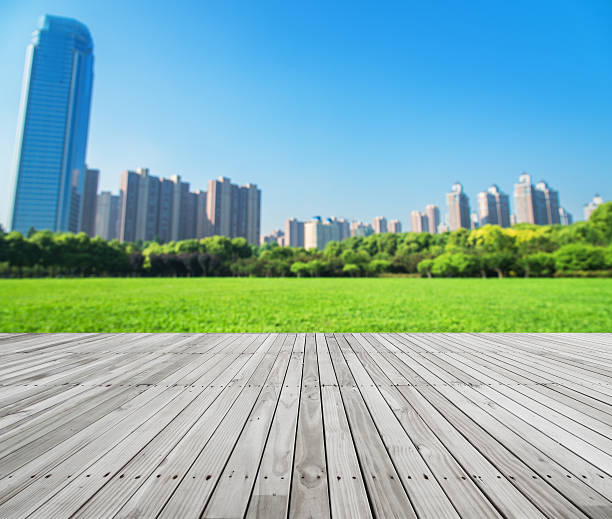 istock Wooden platform with city park defocused blurred abstract background 590065496