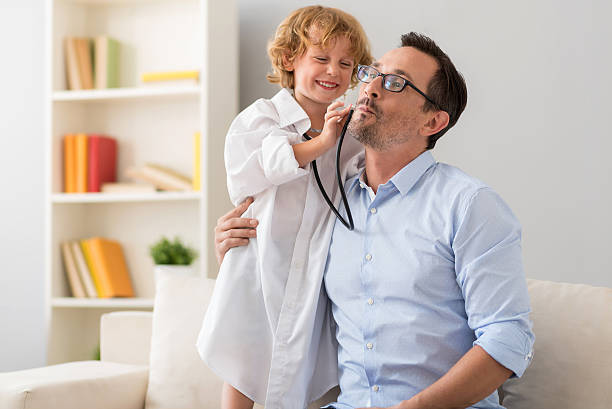 little boy treating his father - attentively imagens e fotografias de stock