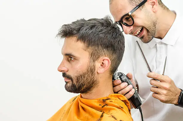 Photo of Hairdresser with glasses wearing a white shirt  haircut customer