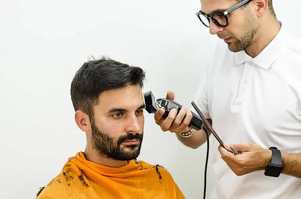 Photo of Hairdresser with glasses wearing a white shirt  haircut customer