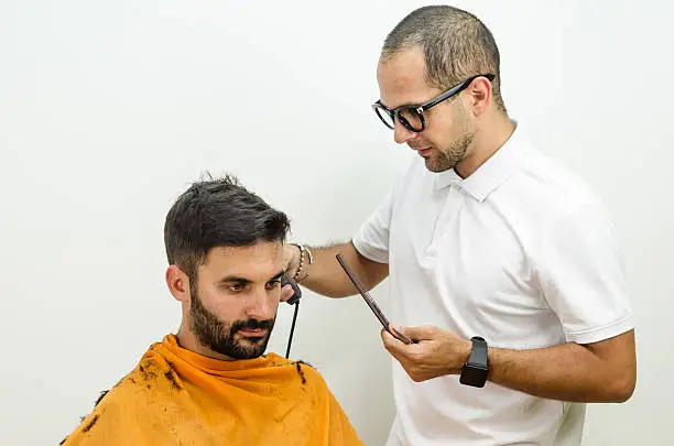 Photo of Hairdresser with glasses wearing a white shirt  haircut customer