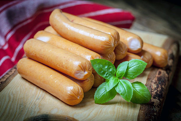 istock Sausages on the wood board. 590068526