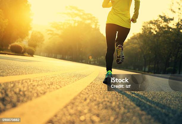 Young Fitness Woman Runner Running On Road Stock Photo - Download Image Now - Running, Jogging, Yellow