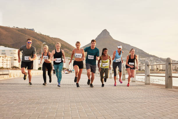 istock Diverse group of young people running race 590071216