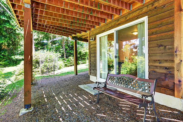 istock Backyard wooden trim house covered patio area 590072474