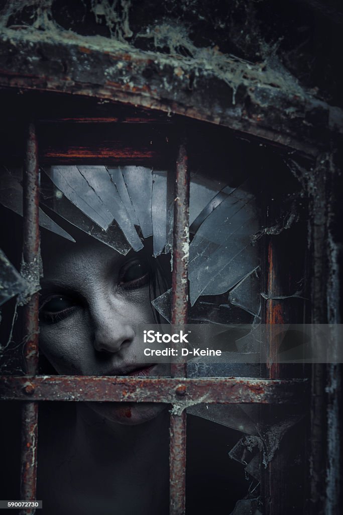 Zombie Zombie looking through a hole. Halloween theme.  Spooky Stock Photo