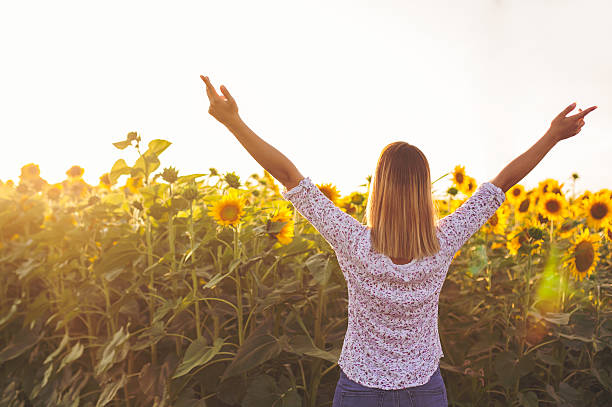istock Girl in a sunflower field 590072750