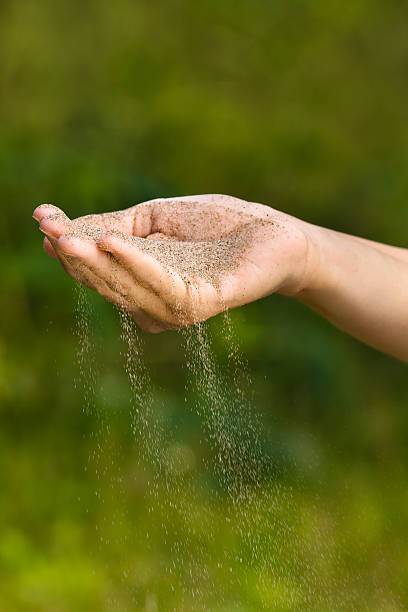 istock sand running through fingers like time running out 590073138