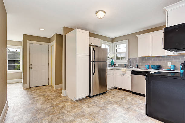 istock Kitchen room interior with white cabinets and tile floor. 590074380