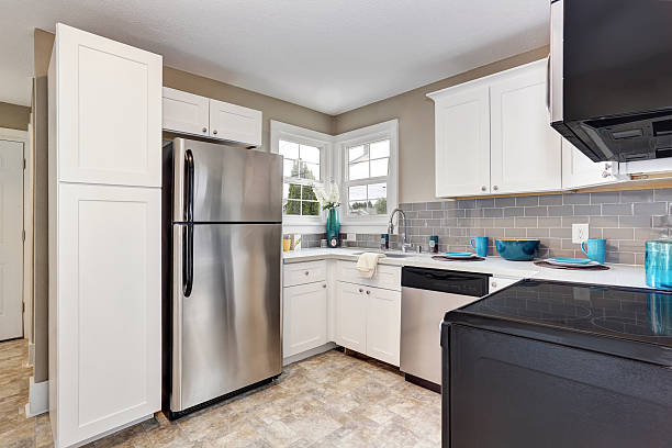istock Kitchen room interior with white cabinets and tile floor. 590074426