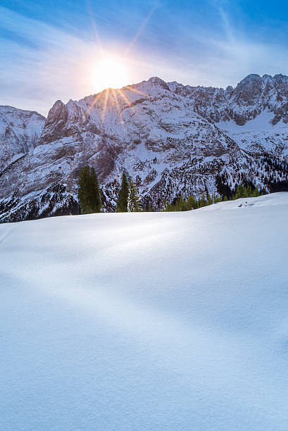 istock Winter sun over snowy mountain peaks 590075726