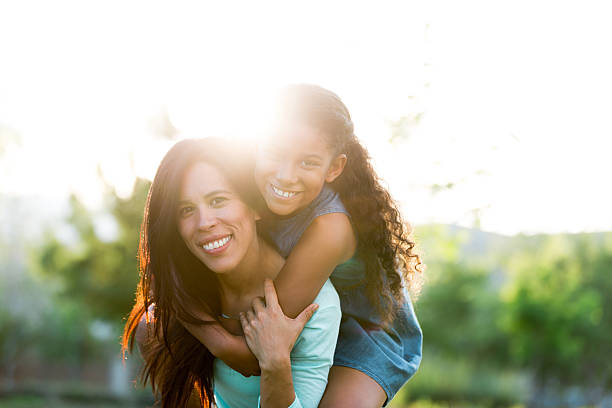 istock Beautiful mother and daughter outdoors in backlight 590076360