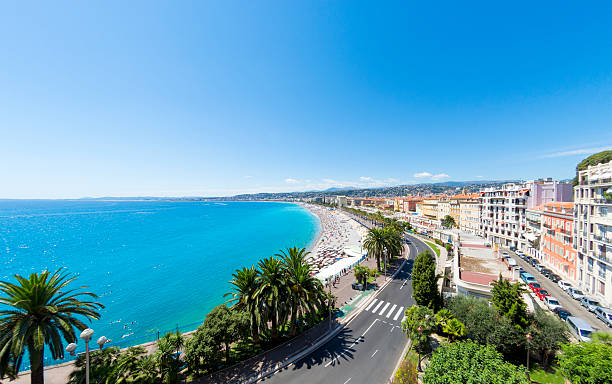 Promenade des Anglais and beach in Nice, France A view along the Promenade des Anglais and beach and seafront in Nice, France. Logos removed. french riviera stock pictures, royalty-free photos & images