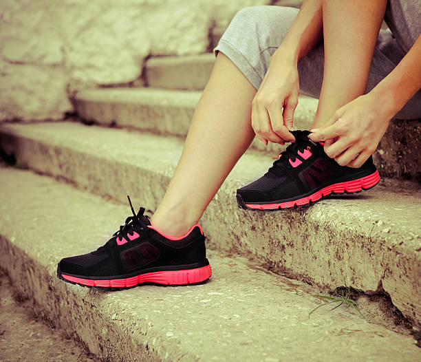 istock Woman trying running shoes getting ready for jogging 590079478