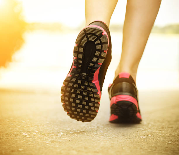 istock Runner feet running on road closeup  shoes 590080246